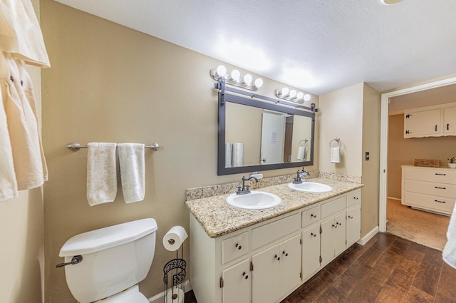 1096 Twain Ave W, Fresno, CA 93711 - full bath with double vanity, wood finished floors, toilet, and baseboards