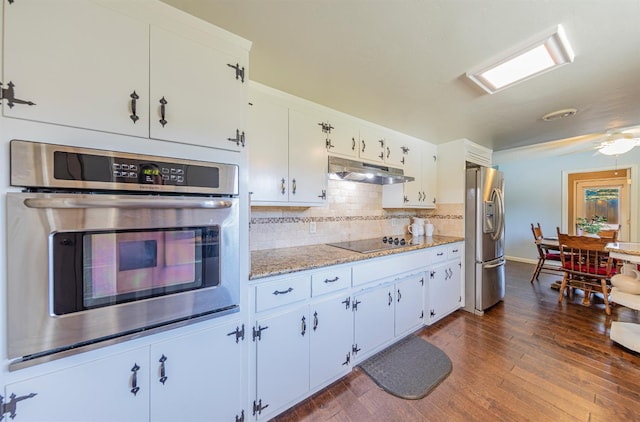 1096 Twain Ave W, Fresno, CA 93711 - kitchen with appliances with stainless steel finishes, under cabinet range hood, dark wood-type flooring, backsplash, and white cabinets