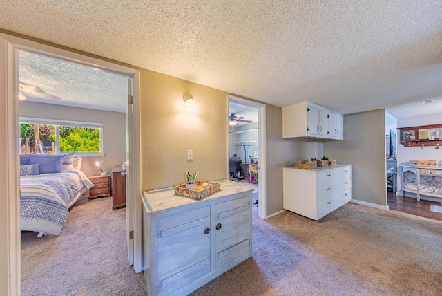 1096 Twain Ave W, Fresno, CA 93711 - kitchen featuring carpet, a textured ceiling, light countertops, ceiling fan, and white cabinetry