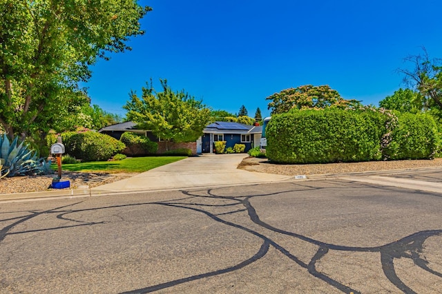 1096 Twain Ave W, Fresno, CA 93711 - obstructed view of property with driveway and roof mounted solar panels