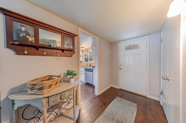 1096 Twain Ave W, Fresno, CA 93711 - foyer featuring dark wood-style flooring, a textured ceiling, and baseboards