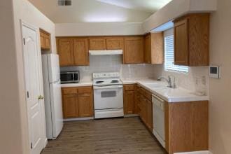 9872 N Woodrow Ave, Fresno, CA 93720 - kitchen with white appliances, range hood, brown cabinetry, and wood finished floors