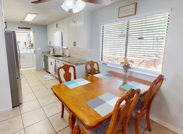 33491 Rd 233, North Fork, CA 93643 - dining area with washer / dryer, a ceiling fan, light tile patterned floors, and baseboards