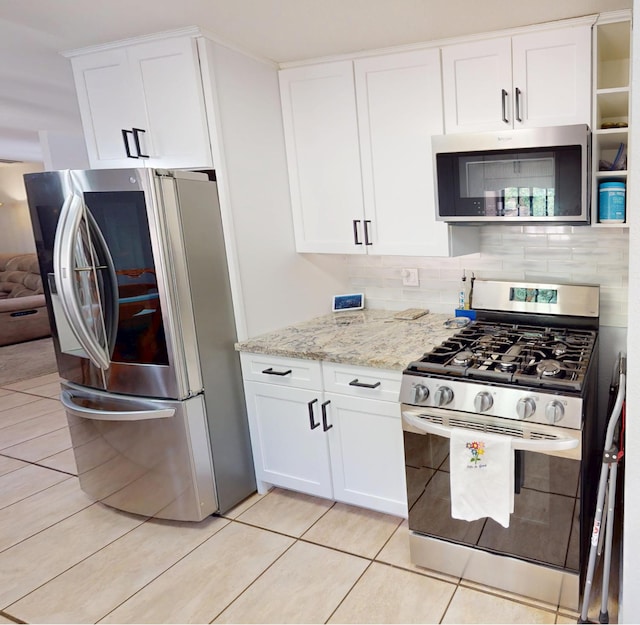 33491 Rd 233, North Fork, CA 93643 - kitchen featuring appliances with stainless steel finishes, white cabinetry, light stone countertops, and backsplash