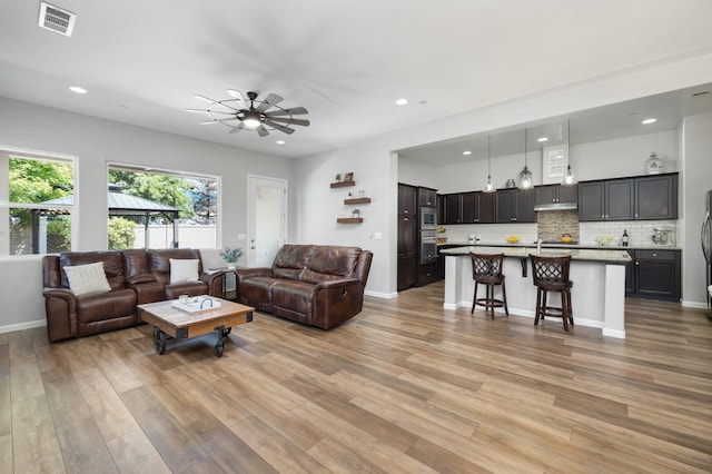 3771 Wrenwood Ave, Clovis, CA 93619 - living area with light wood finished floors, recessed lighting, ceiling fan, and baseboards