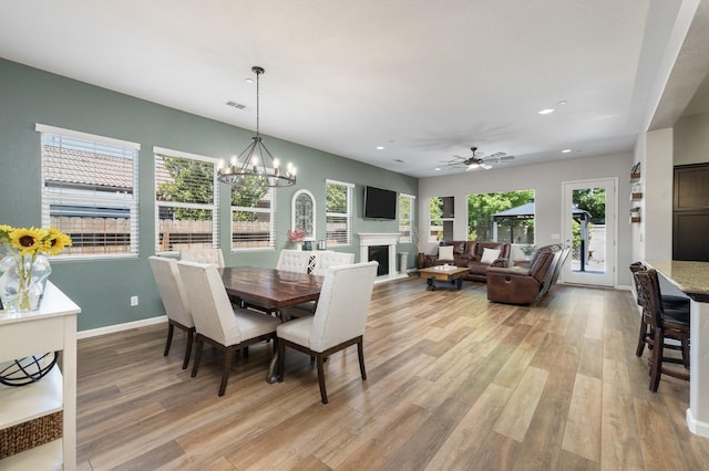 3771 Wrenwood Ave, Clovis, CA 93619 - dining area with light wood-style floors, recessed lighting, baseboards, a ceiling fan, and a chandelier