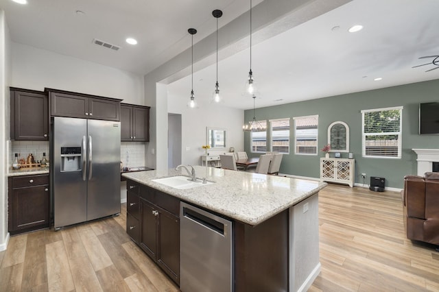 3771 Wrenwood Ave, Clovis, CA 93619 - kitchen featuring appliances with stainless steel finishes, a sink, open floor plan, dark brown cabinetry, and recessed lighting