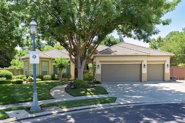 1413 N Hornet Ave, Clovis, CA 93619 - view of front of house featuring stucco siding, driveway, a garage, and a tiled roof