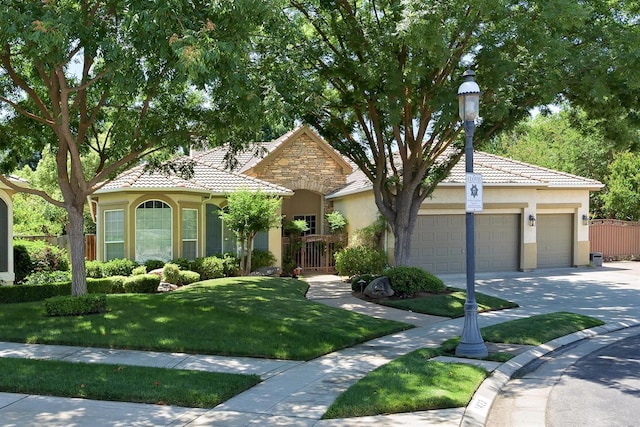 1413 N Hornet Ave, Clovis, CA 93619 - view of front of house featuring stucco siding, a tile roof, concrete driveway, and a garage