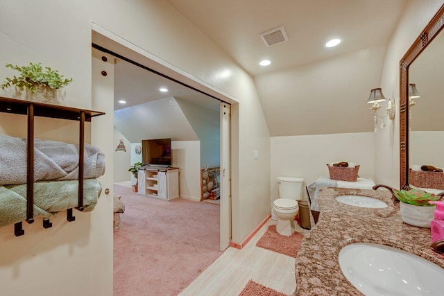 35859 Rd 222, Wishon, CA 93669 - bathroom featuring lofted ceiling, double vanity, toilet, recessed lighting, and wood finished floors