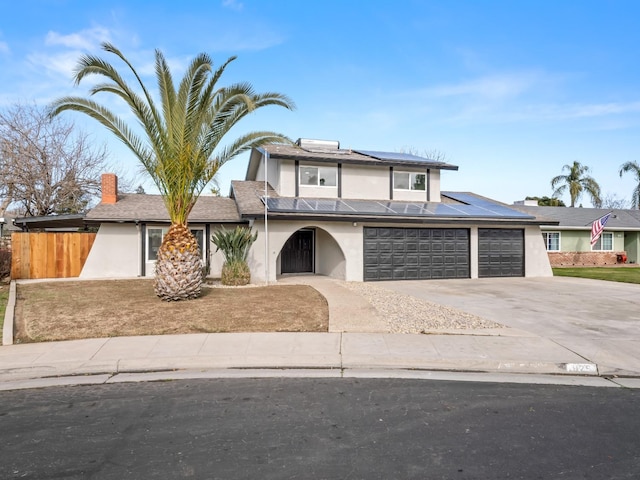 829 Polson Ave, Clovis, CA 93612 - view of front of home featuring stucco siding, solar panels, driveway, and an attached garage