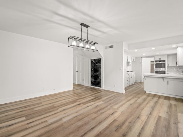 829 Polson Ave, Clovis, CA 93612 - unfurnished living room with light wood-type flooring, recessed lighting, and baseboards