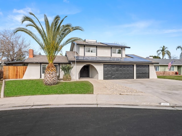 829 Polson Ave, Clovis, CA 93612 - view of front facade with stucco siding, solar panels, driveway, and a garage