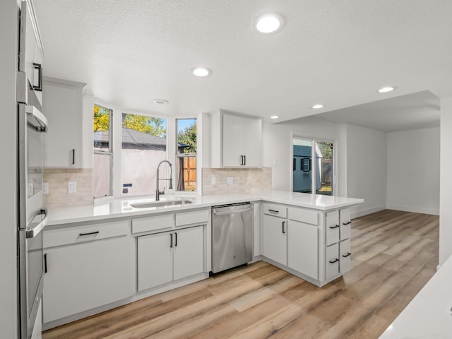 829 Polson Ave, Clovis, CA 93612 - kitchen featuring appliances with stainless steel finishes, a sink, decorative backsplash, light countertops, and recessed lighting