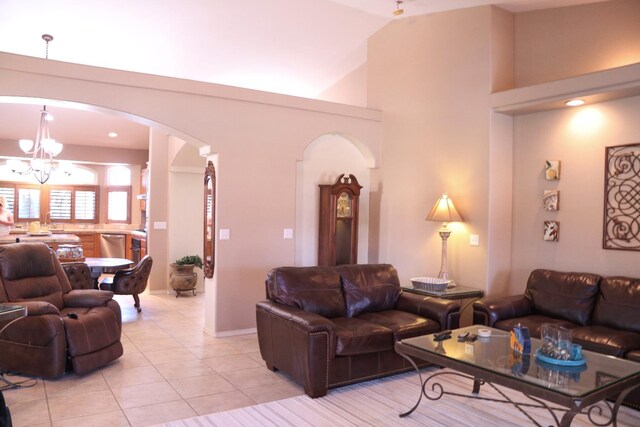 3055 Glenville Ave, Madera, CA 93637 - living area featuring a chandelier, light tile patterned floors, arched walkways, and high vaulted ceiling