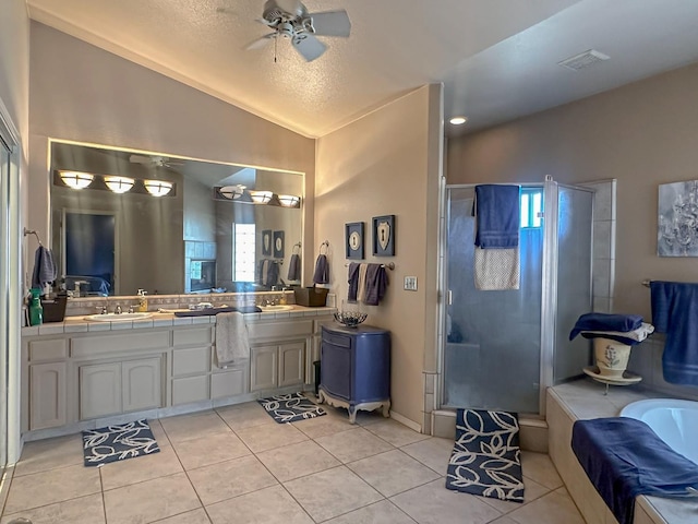 3055 Glenville Ave, Madera, CA 93637 - bathroom featuring tile patterned floors, lofted ceiling, a stall shower, double vanity, and a bath