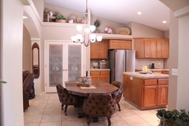 3055 Glenville Ave, Madera, CA 93637 - dining room featuring arched walkways, a chandelier, light tile patterned floors, and recessed lighting