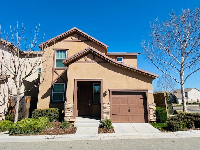 1507 N Strada Way, Clovis, CA 93619 - view of front of home featuring stone siding, stucco siding, an attached garage, and concrete driveway