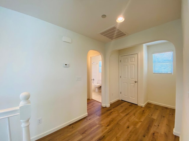 1507 N Strada Way, Clovis, CA 93619 - spare room with arched walkways, wood finished floors, baseboards, and recessed lighting