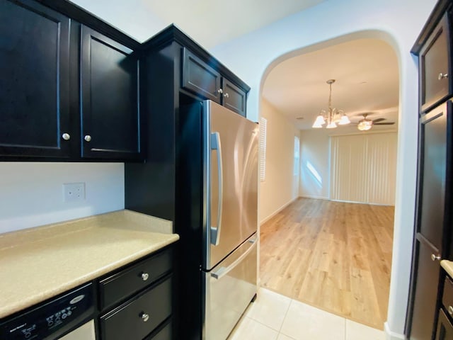1507 N Strada Way, Clovis, CA 93619 - kitchen with freestanding refrigerator, a chandelier, light countertops, dark cabinets, and decorative light fixtures