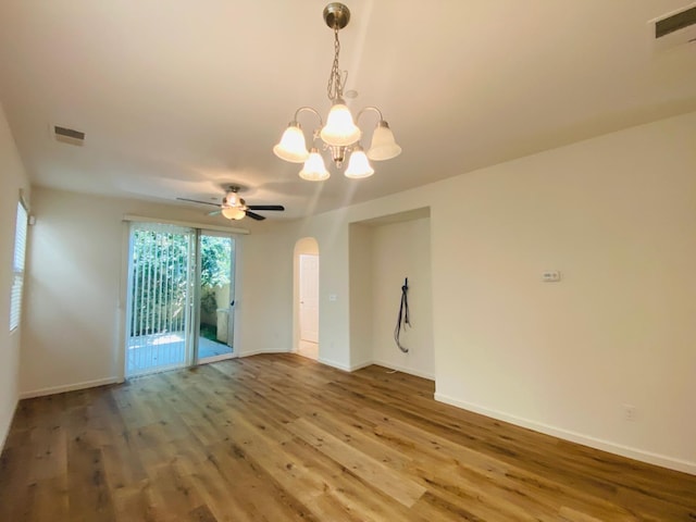 1507 N Strada Way, Clovis, CA 93619 - unfurnished room featuring wood finished floors, arched walkways, a chandelier, and baseboards