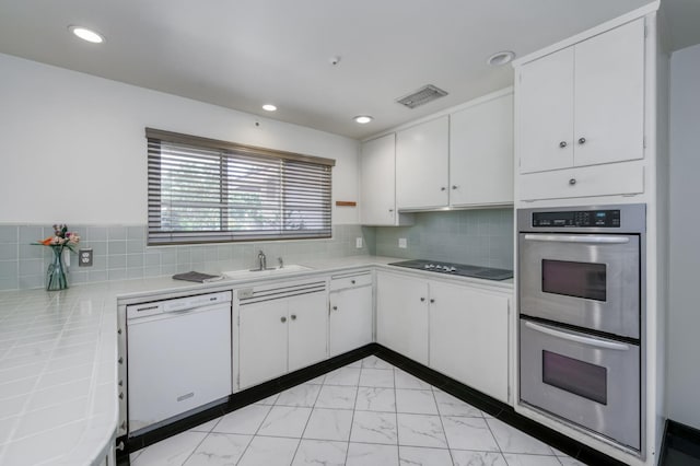 136 E Simpson Ave, Fresno, CA 93704 - kitchen featuring dishwasher, stainless steel double oven, black electric cooktop, light marble finish floors, and a sink