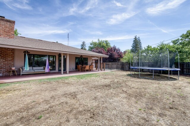 136 E Simpson Ave, Fresno, CA 93704 - fenced backyard with a trampoline and a patio