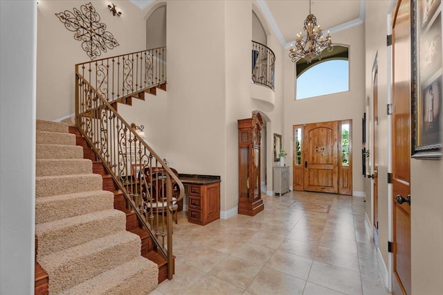 2707 W Menlo Ave, Fresno, CA 93711 - foyer entrance featuring a chandelier, ornamental molding, stairway, arched walkways, and a high ceiling