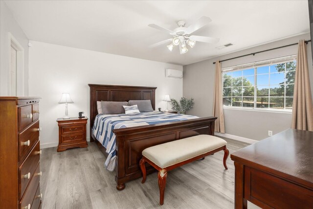 30015 Stetson Dr, Coarsegold, CA 93614 - bedroom featuring an AC wall unit, light wood-type flooring, baseboards, and ceiling fan