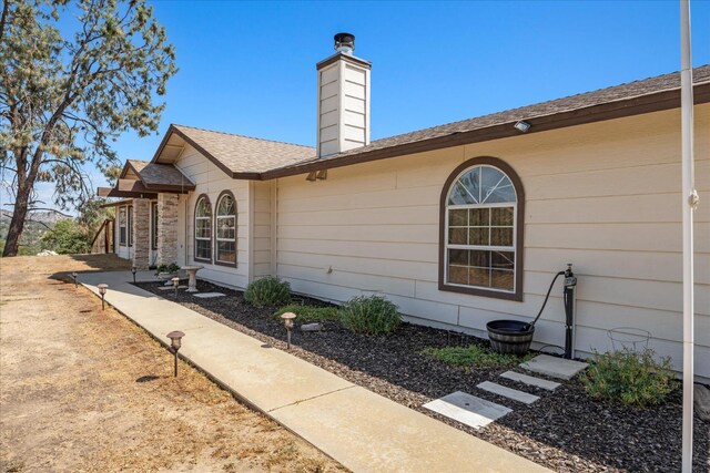 30015 Stetson Dr, Coarsegold, CA 93614 - view of side of home with a chimney and a shingled roof