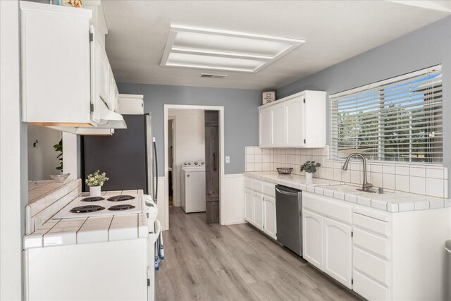 30015 Stetson Dr, Coarsegold, CA 93614 - kitchen featuring appliances with stainless steel finishes, washer / clothes dryer, tile countertops, and white cabinets