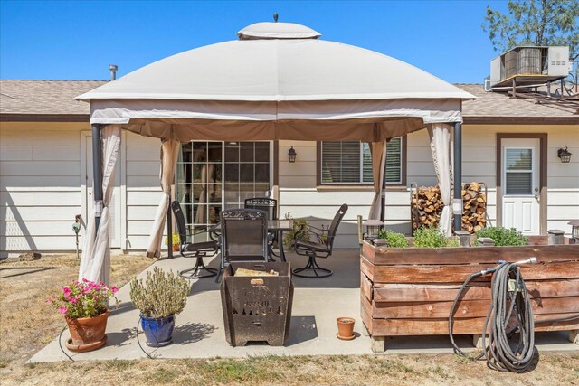 30015 Stetson Dr, Coarsegold, CA 93614 - rear view of property featuring a patio, central AC unit, outdoor dining area, and a shingled roof