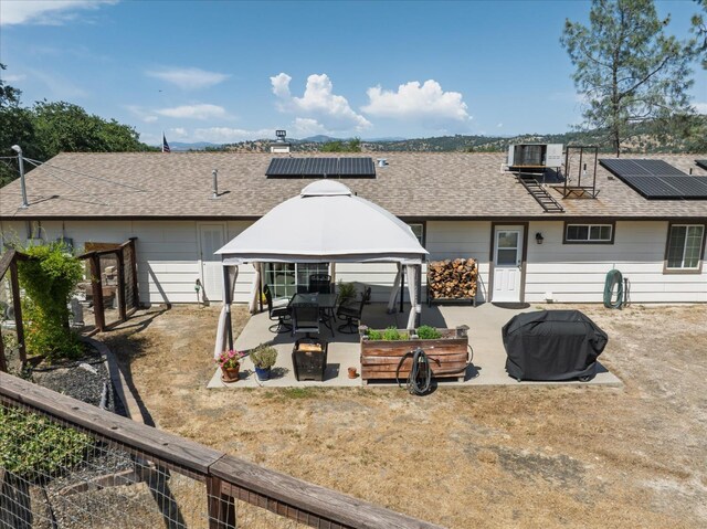 30015 Stetson Dr, Coarsegold, CA 93614 - back of property with a gazebo, a patio area, solar panels, and roof with shingles