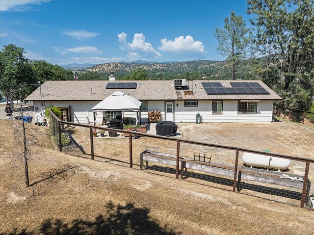 30015 Stetson Dr, Coarsegold, CA 93614 - single story home with a gazebo, solar panels, a mountain view, and cooling unit