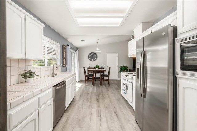 30015 Stetson Dr, Coarsegold, CA 93614 - kitchen with appliances with stainless steel finishes, a sink, white cabinetry, and tile countertops