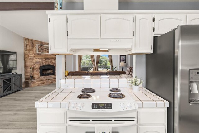 30015 Stetson Dr, Coarsegold, CA 93614 - kitchen with tile countertops, white range with electric cooktop, stainless steel refrigerator with ice dispenser, white cabinetry, and vaulted ceiling