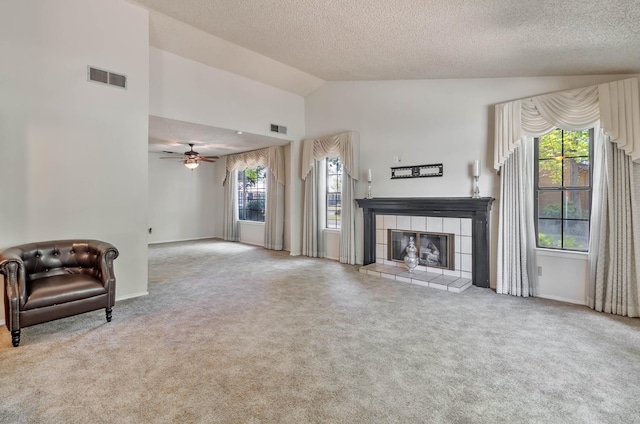 4633 N Glenn Ave, Fresno, CA 93704 - unfurnished living room featuring carpet flooring, a fireplace, a textured ceiling, baseboards, and ceiling fan