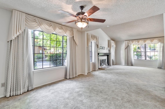 4633 N Glenn Ave, Fresno, CA 93704 - unfurnished living room featuring a tile fireplace, a textured ceiling, carpet flooring, ceiling fan, and vaulted ceiling