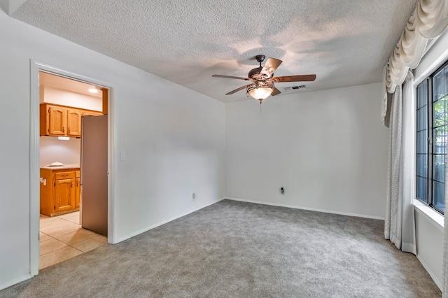 4633 N Glenn Ave, Fresno, CA 93704 - unfurnished room featuring light colored carpet, ceiling fan, a textured ceiling, and baseboards