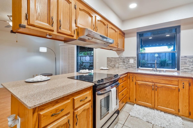 4633 N Glenn Ave, Fresno, CA 93704 - kitchen featuring stainless steel range with electric stovetop, a peninsula, tasteful backsplash, light stone countertops, and a sink