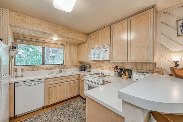 62681 Huntington Vista Ln # 111, Lakeshore, CA 93634 - kitchen with white appliances, a sink, light brown cabinetry, a peninsula, and light countertops