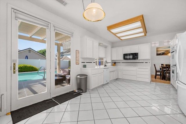 2162 Decatur Ave, Clovis, CA 93611 - kitchen with black microwave, dishwasher, light countertops, and white cabinets