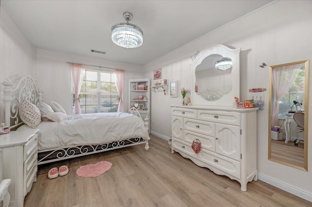 2162 Decatur Ave, Clovis, CA 93611 - bedroom featuring light wood finished floors, baseboards, and a chandelier