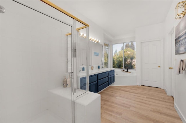 2162 Decatur Ave, Clovis, CA 93611 - full bath featuring a stall shower, double vanity, wood finished floors, and a bath