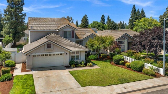 2162 Decatur Ave, Clovis, CA 93611 - view of front of property with a tile roof, a garage, concrete driveway, and stucco siding