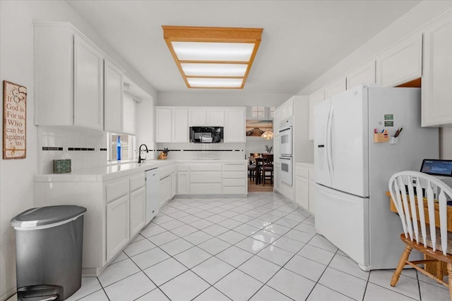 2162 Decatur Ave, Clovis, CA 93611 - kitchen with white appliances, white cabinetry, a sink, light tile patterned floors, and backsplash