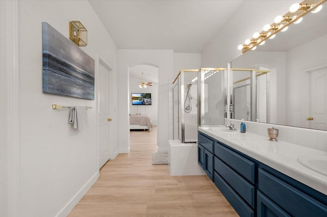 2162 Decatur Ave, Clovis, CA 93611 - full bathroom with connected bathroom, a stall shower, double vanity, wood finished floors, and a ceiling fan