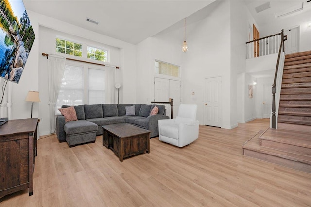 2162 Decatur Ave, Clovis, CA 93611 - living room featuring light wood-type flooring, stairs, and a high ceiling