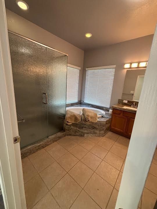 2136 Florence Ave, Sanger, CA 93657 - bathroom with tile patterned floors, vanity, a bath, a stall shower, and recessed lighting