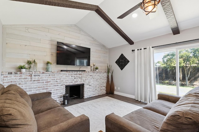 1583 San Gabriel Ave, Clovis, CA 93611 - living area featuring baseboards, wooden walls, wood finished floors, ceiling fan, and a fireplace